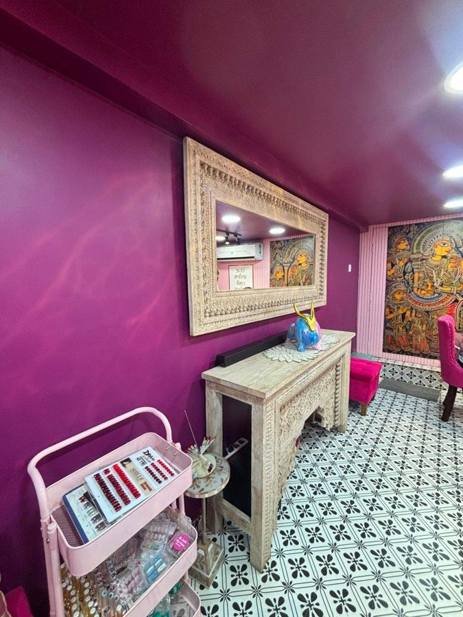 Carved console with Madhubani art in the magenta lounge