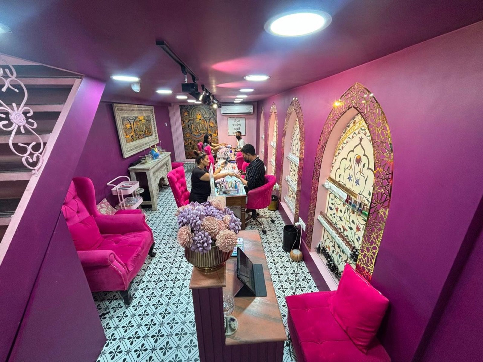 The SoBo Nail Salon Seawoods — magenta interior with gold Mughal-arch niches and pink velvet chairs